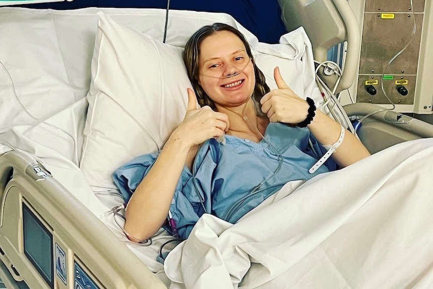 A young woman in a hospital bed.