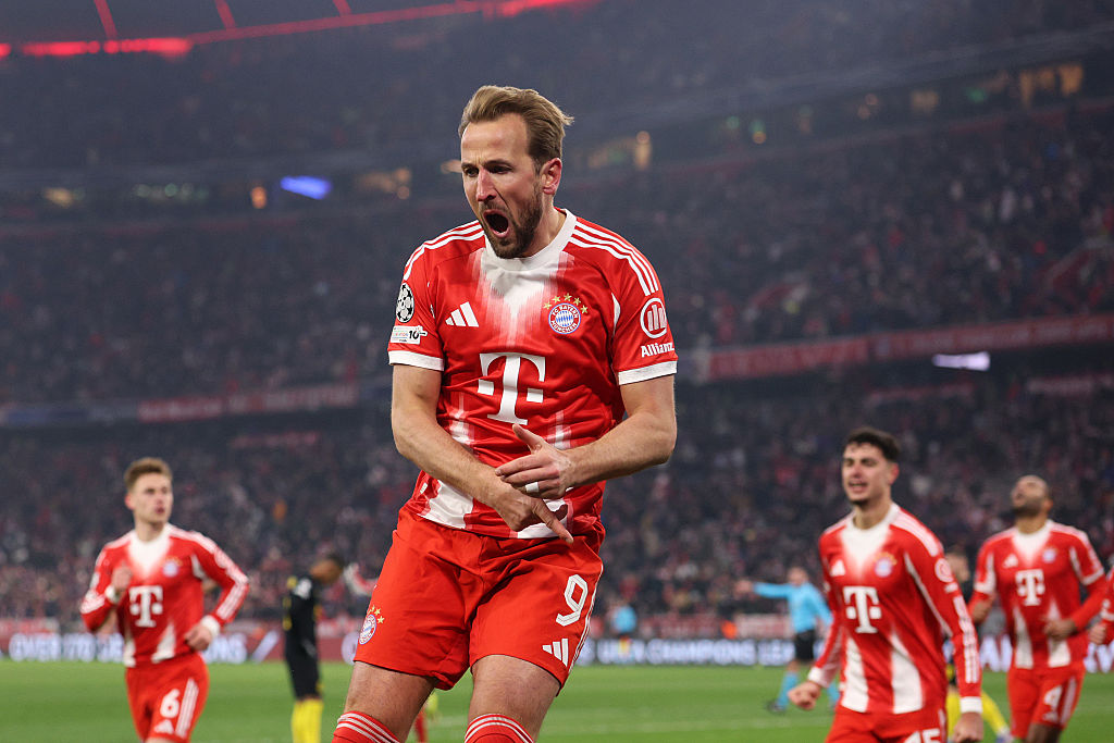 Harry Kane, jumping, of FC Bayern Munich celebrates scoring his team's first goal.