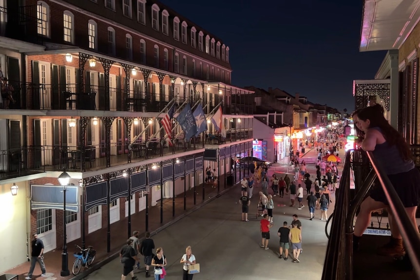 A busy street with people walking around at night.