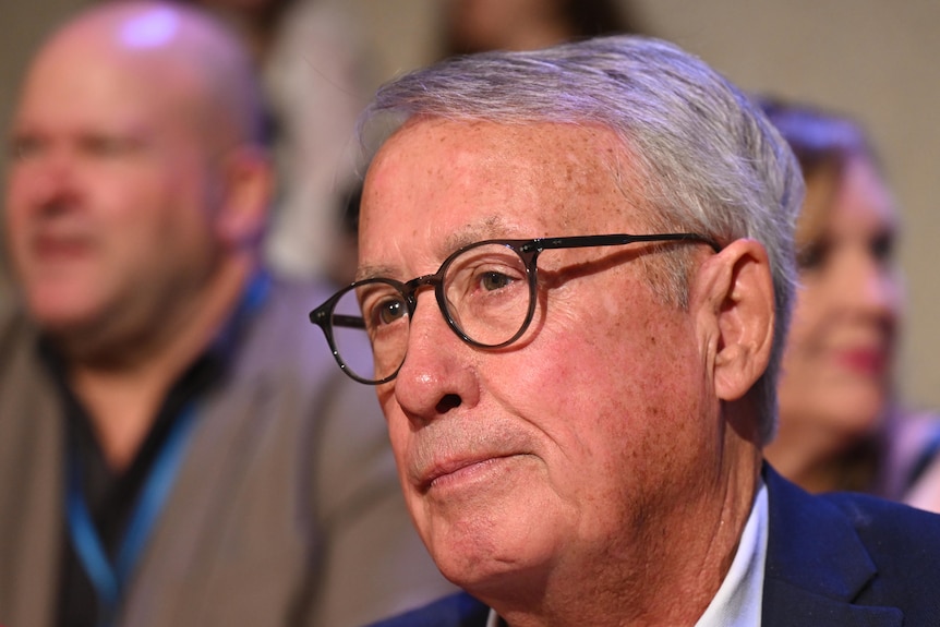A man with glasses and grey hair