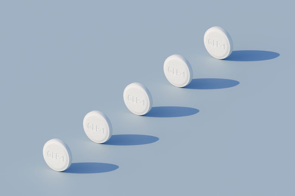GLP-1 weighloss pills - five pills in a row on blue background with harsh lighting - orthographic perspective glp 1 weighloss pills five pills in a row on blue background with harsh lighting orthographic perspective