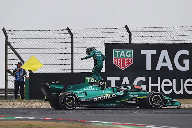 Lance Stroll of Aston Martin F1 Team jumps out of his car.