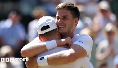 Henry Patten embraces team-mate Harri Heliovaara after winning the Wimbledon men's doubles title