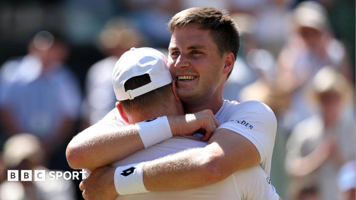 Henry Patten embraces team-mate Harri Heliovaara after winning the Wimbledon men's doubles title