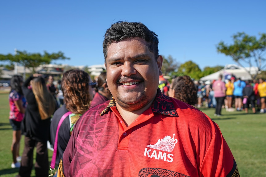 Vincent, a man with a red shirt smiling on the camera.