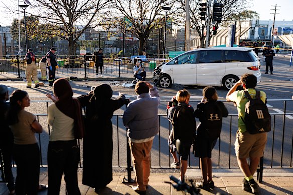 Onlookers at the crash site in Lakemba.