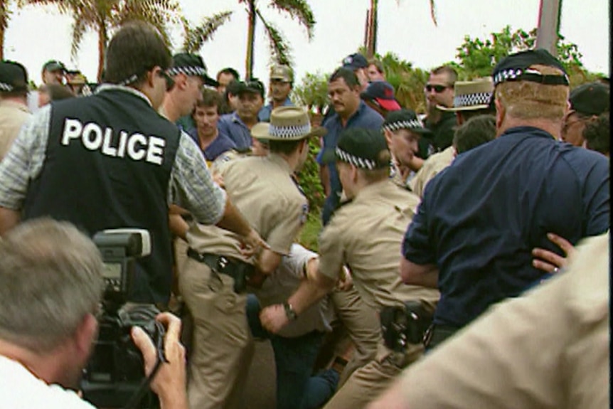 Police crowd strikers in a screenshot from an archival news report.