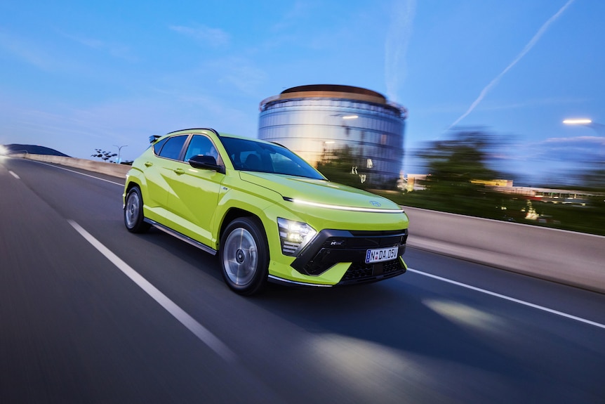 A promotional shot of a ssmall SUV with bright headlights and a higher-mounted band of LEDs.