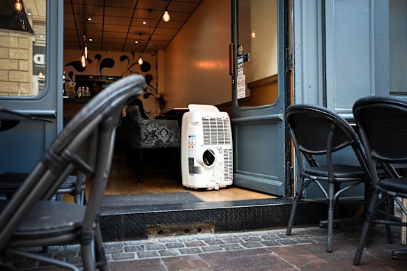 An airconditioning unit in the doorway of a restaurant in Toulouse, France.