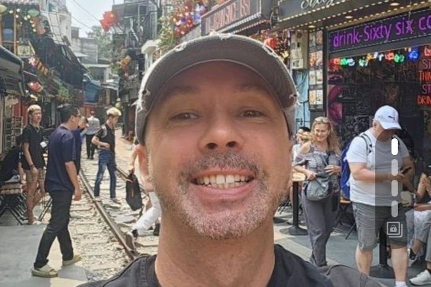 A selfie image of a man wearing a cap