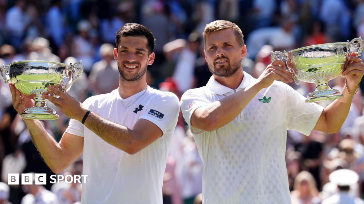 Julian Cash (left) and Lloyd Glasspool pose with their Wimbledon doubles trophies