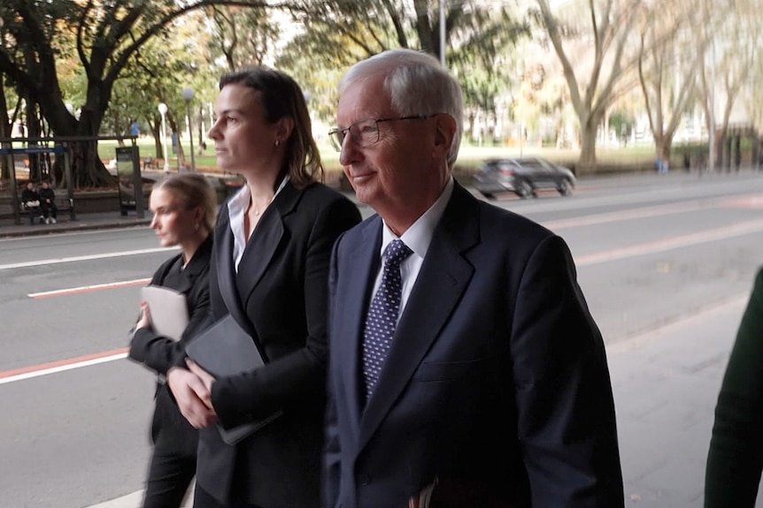 Man in suit walking and smiling