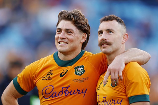 James O'Connor and Nic White of the Wallabies look on.