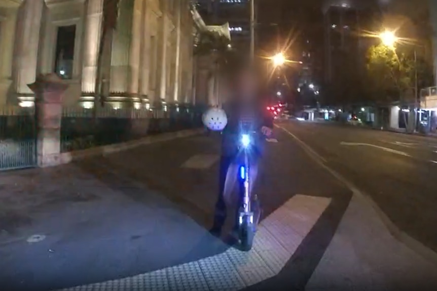 a man riding an e-scooter in brisbane with no helmet on