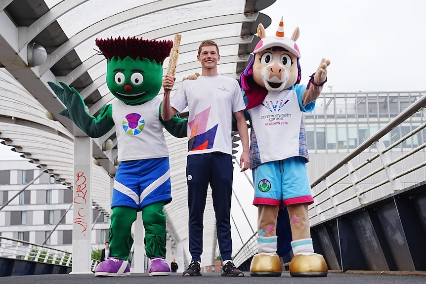 Swimmer Duncan Scott with 2026 Glasgow Commonwealth Games mascots Clyde and Finnie.