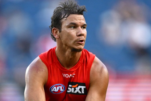 Daniel Rioli of the Suns handballs during the round four AFL match between Melbourne Demons and Gold Coast Suns at Melbourne Cricket Ground, on April 05, 2026, in Melbourne, Australia. 