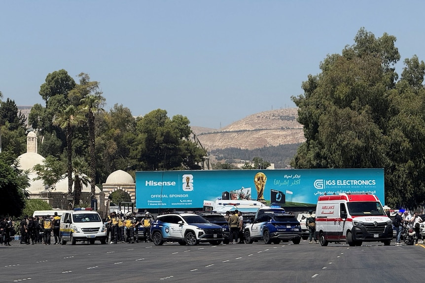 Emergency vehicles outside a hotel complex in desert setting