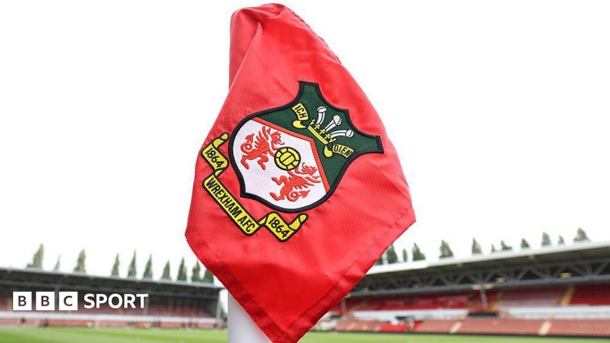 Red corner flag with Wrexham logo inside the Racecourse Ground
