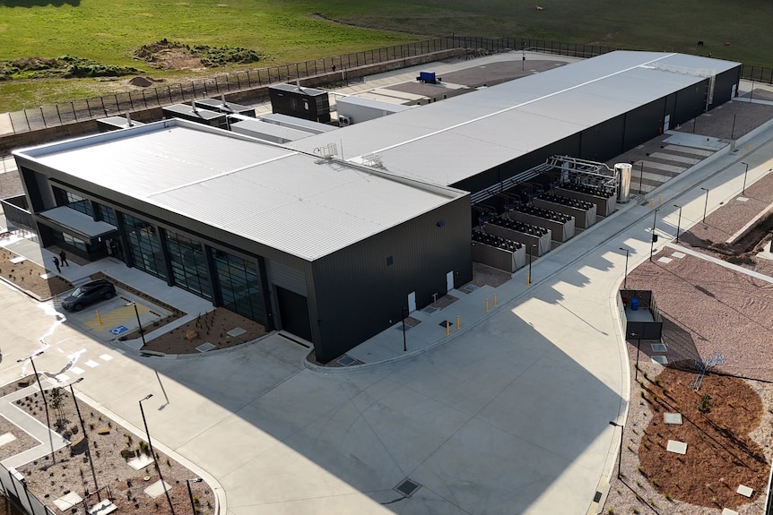 image of black building with water tanks and infrastructure