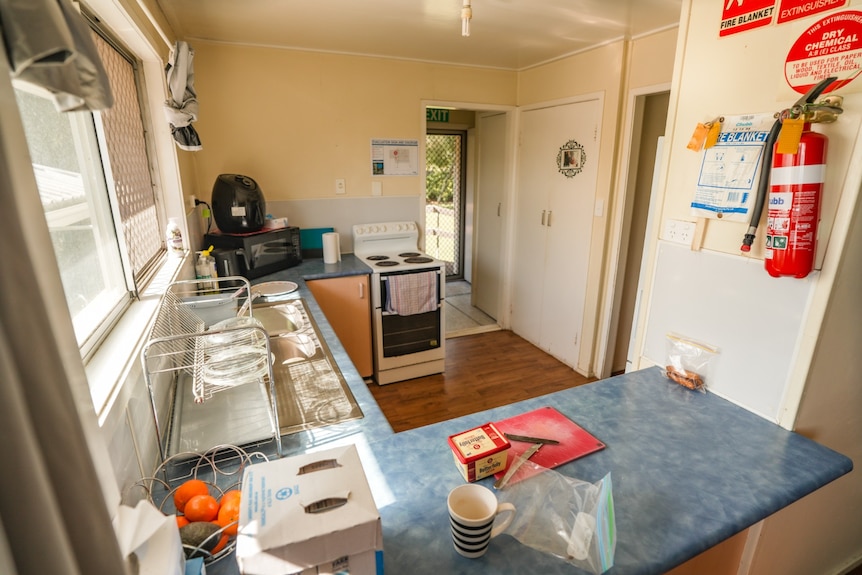 A kitchen with a chopping board and butter on the countertop.