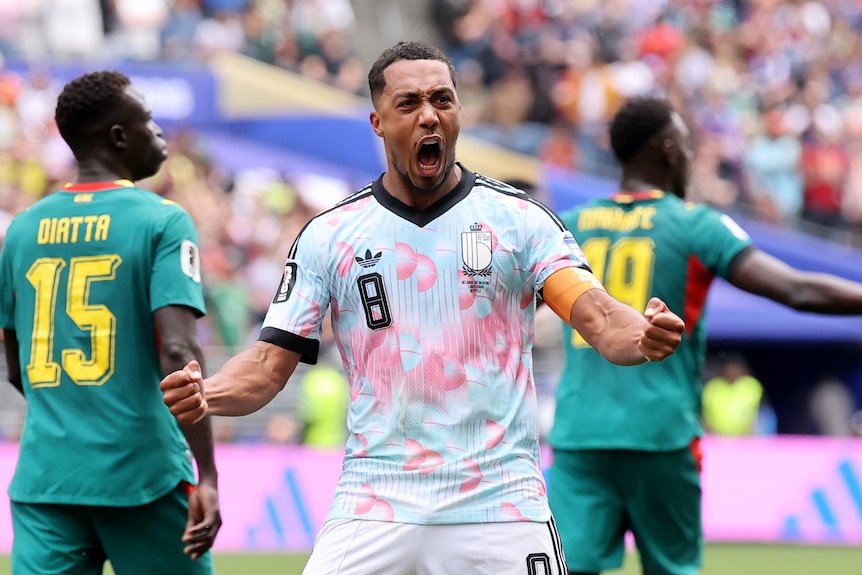 Youri Tielemans clenches his fists and roars with delight