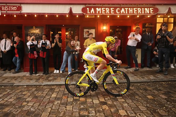 Tadej Pogačar, wearing the overall leader’s yellow jersey, rides in the Montmartre district during the final stage of the Tour de France last year. 