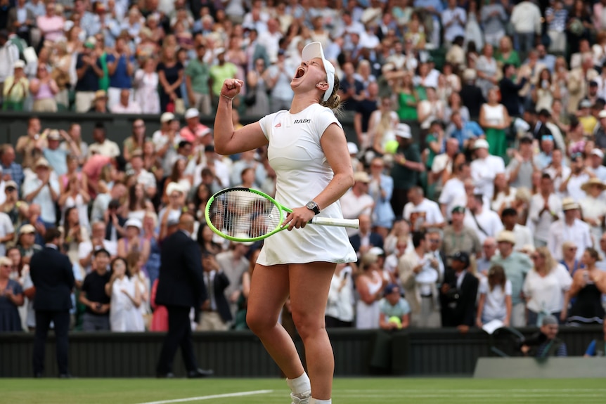 Barbora Krejcikova roars into the air to celebrate at Wimbledon.