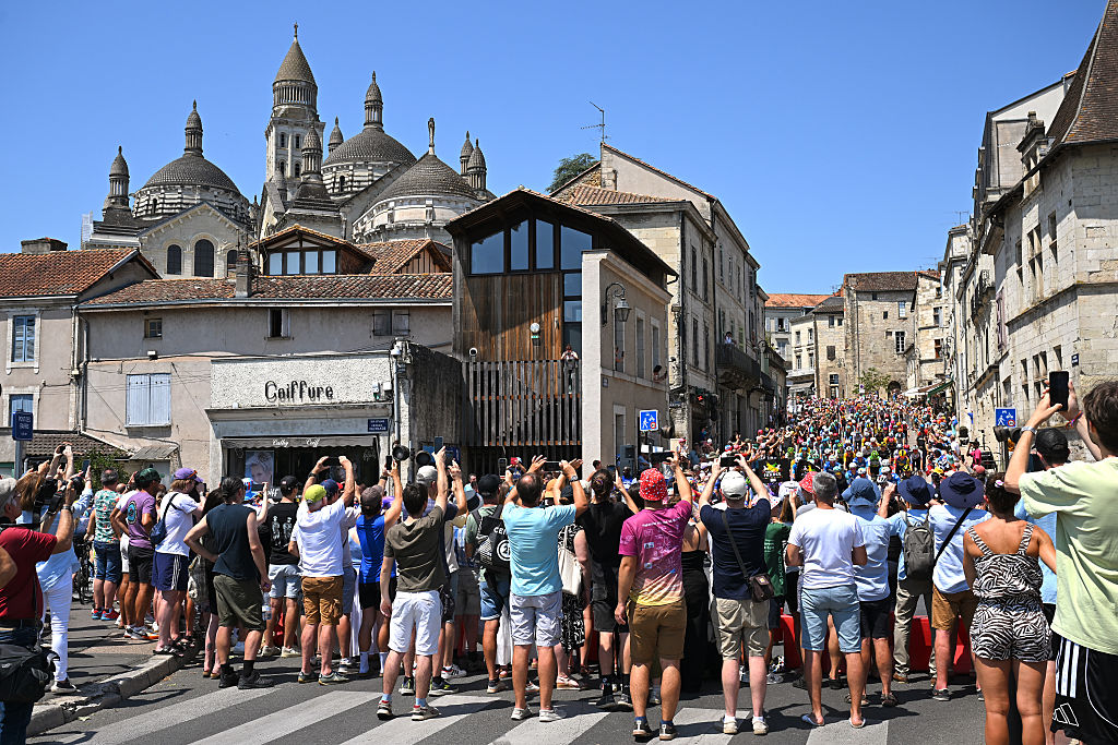 PERIGUEUX, FRANCE - JULY 11: A general view of the peloton passing through a Perigueux while fans cheers prior to the 113th Tour de France 2026, Stage 8 a 180.4km stage from Perigueux to Bergerac / #UCIWT / on July 11, 2026 in Perigueux, France. (Photo by Tim de Waele/Getty Images)