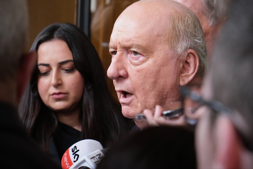Alan Jones speaking outside court.