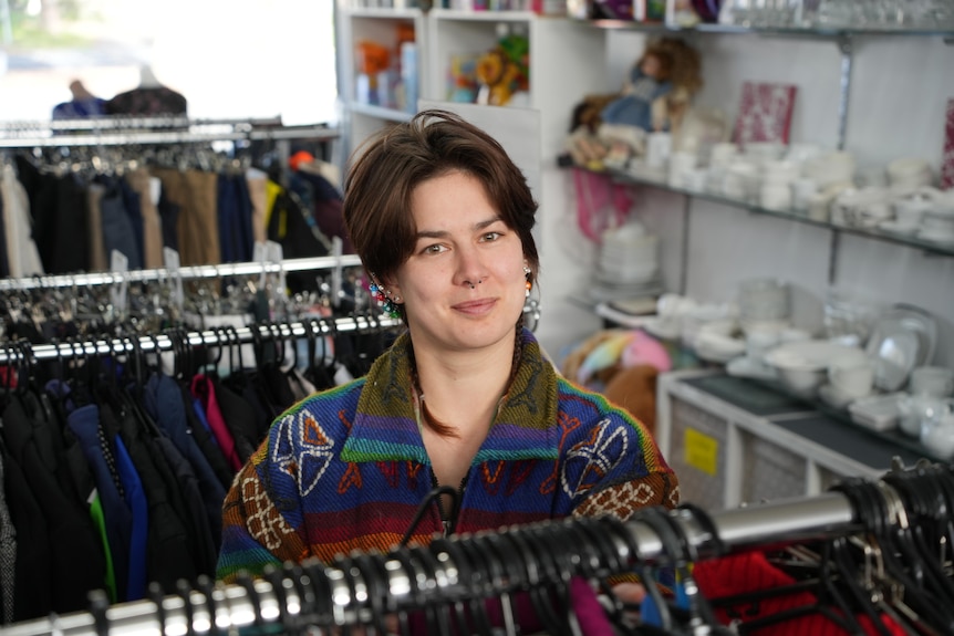 Woman with short dark hair and colourful jacket.