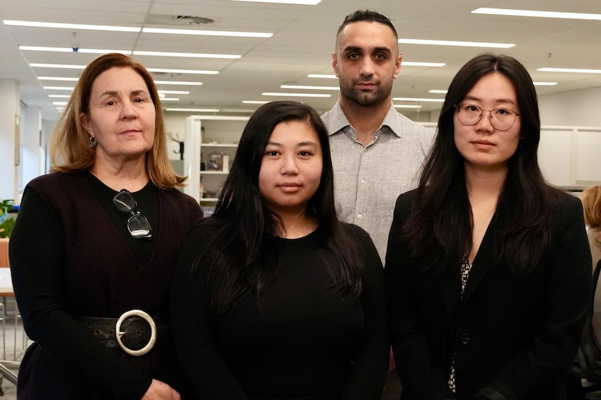 A team of lawyers stands side-by-side