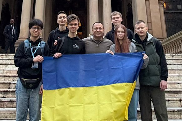 Australia’s ambassador to Ukraine, Vasyl Myroshnychenko, pictured with the Ukrainian teenager competing at the International Cyber Olympiad in AI in Sydney.