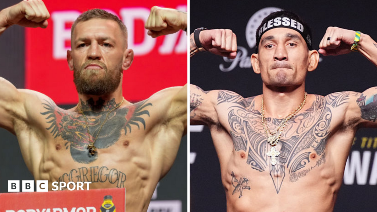 Conor McGregor holds up his arms and Max Holloway holds up his arms