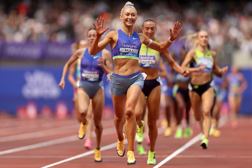 A woman celebrates winning a race.