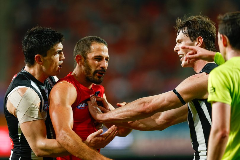 Ben Long of the Suns is seen arguing with an umpire.
