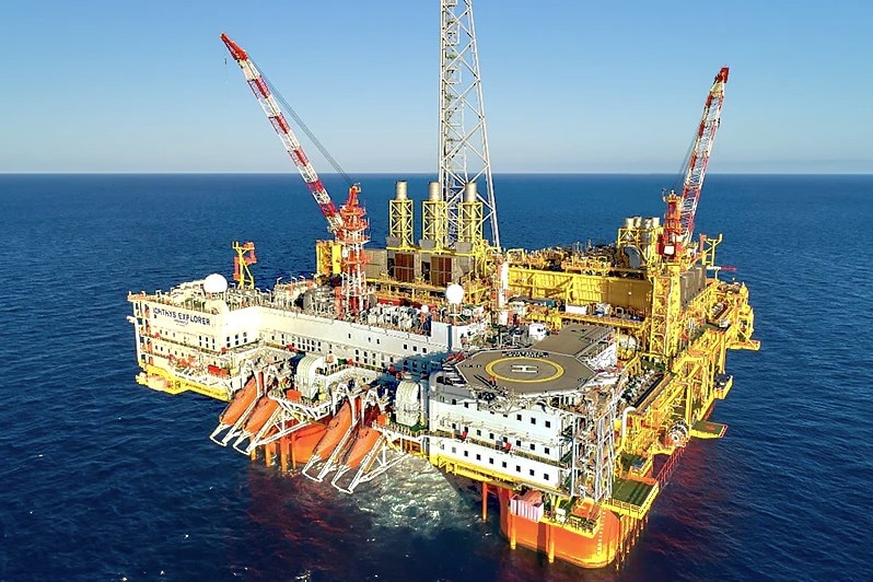 An aerial image of an offshore LNG plant in the middle of the ocean