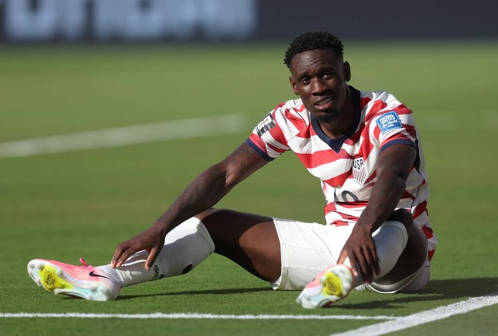 Balogun sits on the ground