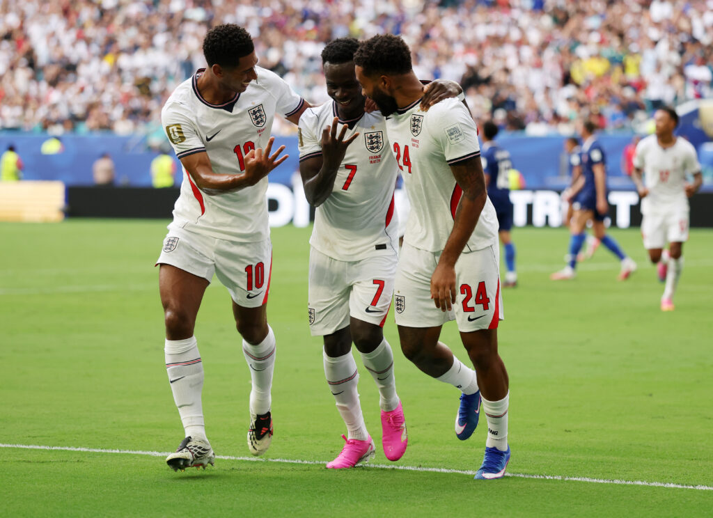 Bukayo Saka #7 of England celebrates scoring his team's fifth goal and his hat trick goal with team mates Jude Bellingham #10 and Reece James #24