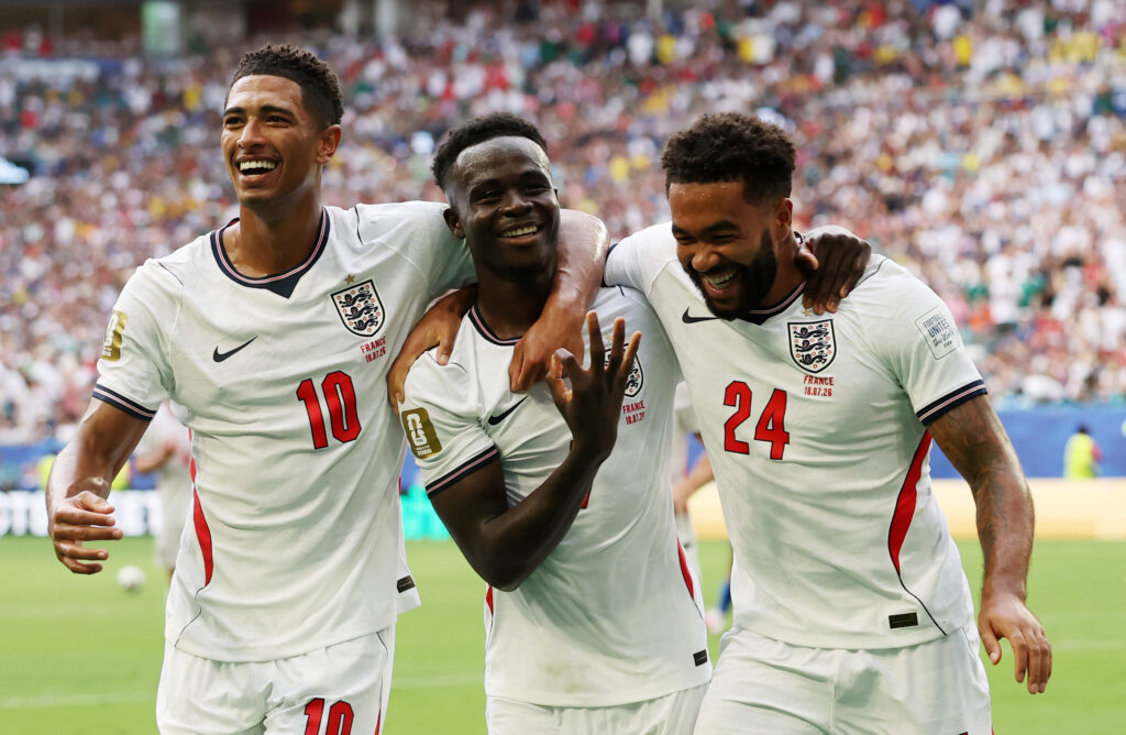 Bukayo Saka #7 of England celebrates scoring his team's fifth and hat trick goal with teammates Jude Bellingham #10 and Reece James #24