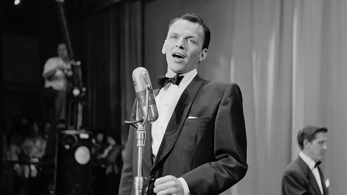 Frank Sinatra performs in a tuxedo and bow tie.
