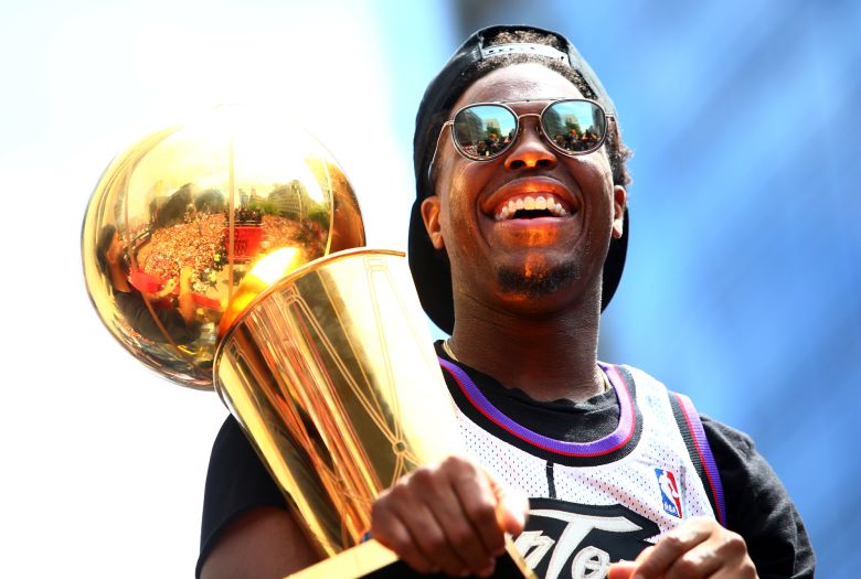 Lowry holding the Larry O'Brien trophy during the Toronto Raptors Victory Parade on June 17, 2019 in Toronto, Canada.