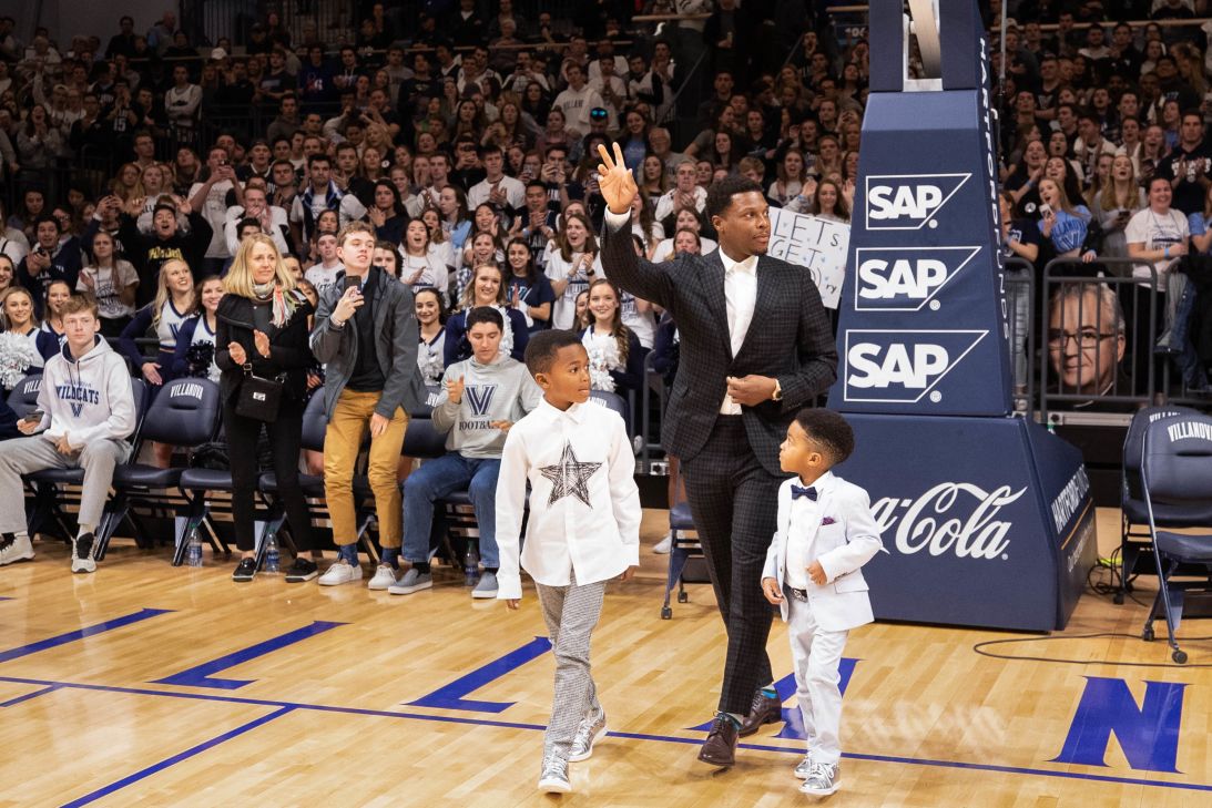 Lowry saluting the crowd as he walks onto the court with his sons Karter and Kameron to get his number retired at Finneran Pavilion on February 26, 2020 in Villanova, Pennsylvania.