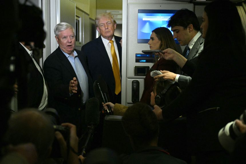 Graham speaks with reporters aboard Air Force One as he accompanies the president back to Washington, DC, on January 4, 2026.