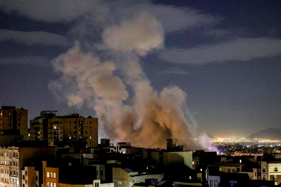 A smoke plume rises following a missile strike on a building in Tehran on March 1, 2026.