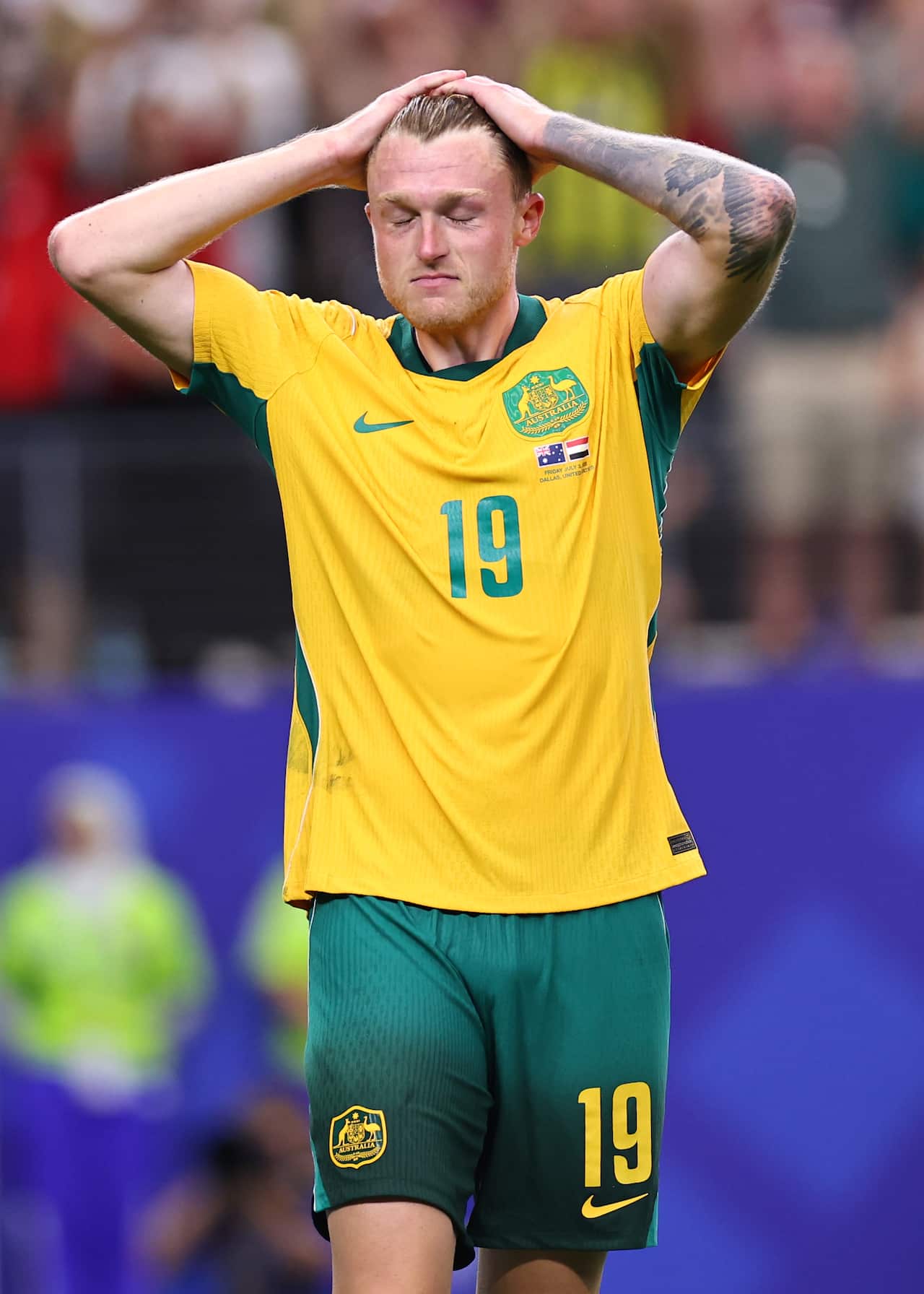 Socceroos defender Harry Souttar stands with his hands on his head and eyes closed after Australia's World Cup round-of-16 defeat to Egypt.