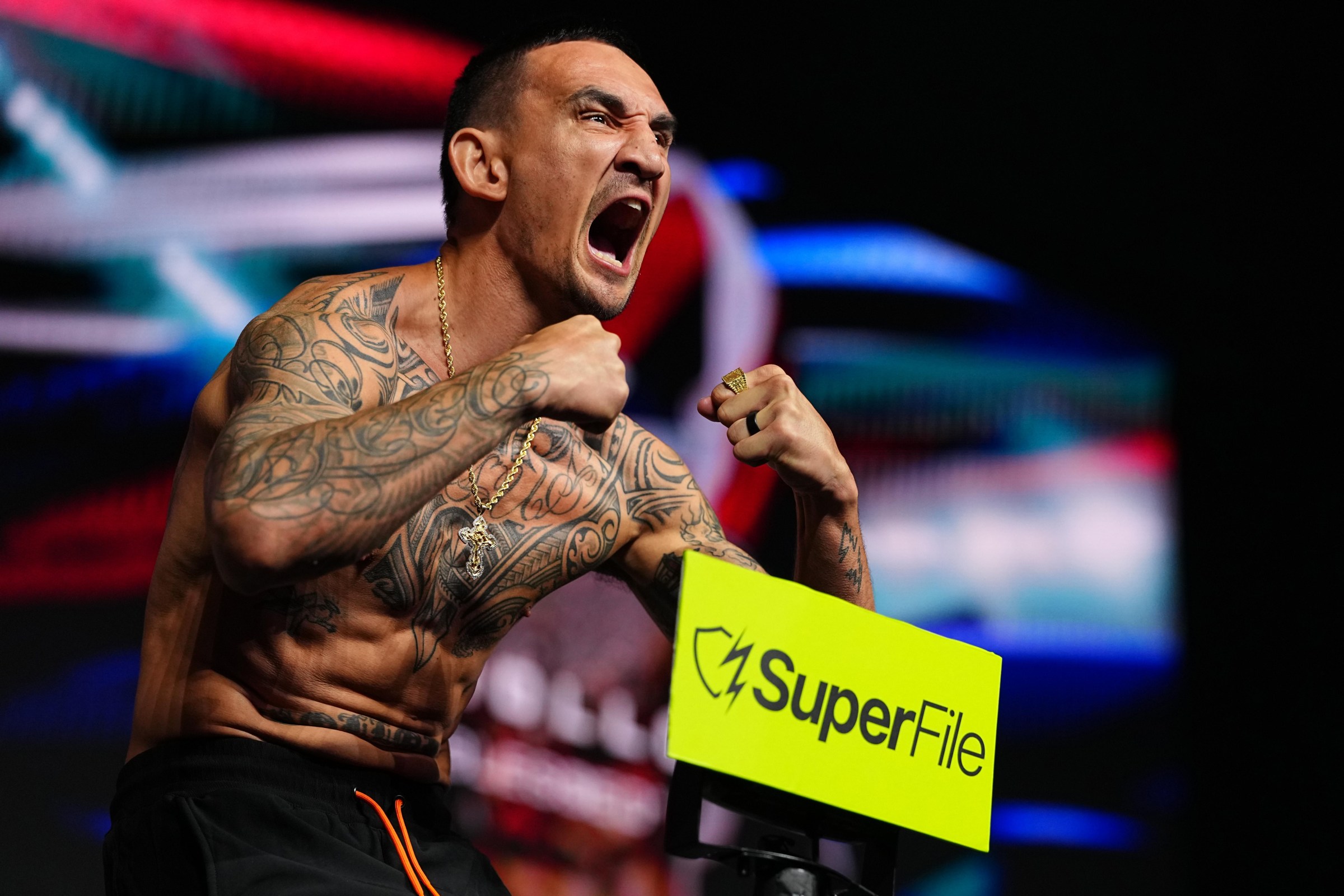 LAS VEGAS, NEVADA - JULY 10: Max Holloway steps on the scale during the UFC 329 ceremonial weigh-in at T-Mobile Arena on July 10, 2026 in Las Vegas, Nevada. (Photo by Chris Unger/Zuffa LLC)