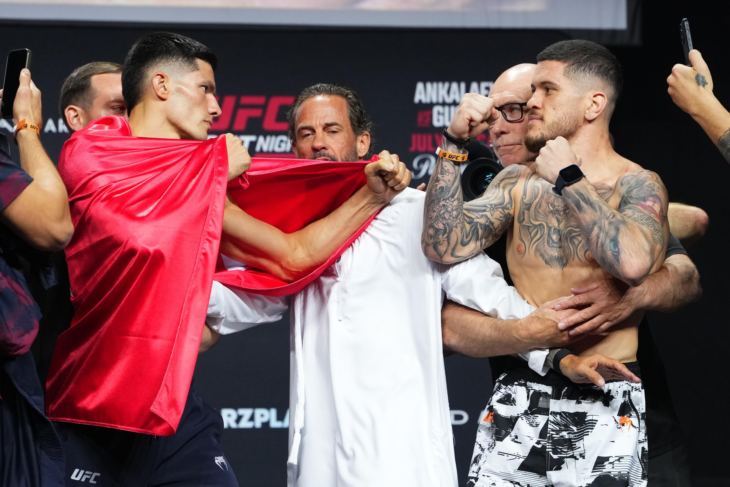 ABU DHABI, UNITED ARAB EMIRATES - JULY 24: (L-R) Opponents Islam Dulatov of Russia and Wellington Turman of Brazil face off during the UFC Fight Night ceremonial weigh-in at Etihad Arena on July 24, 2026 in Abu Dhabi, United Arab Emirates. (Photo by Josh Hedges/Zuffa LLC)