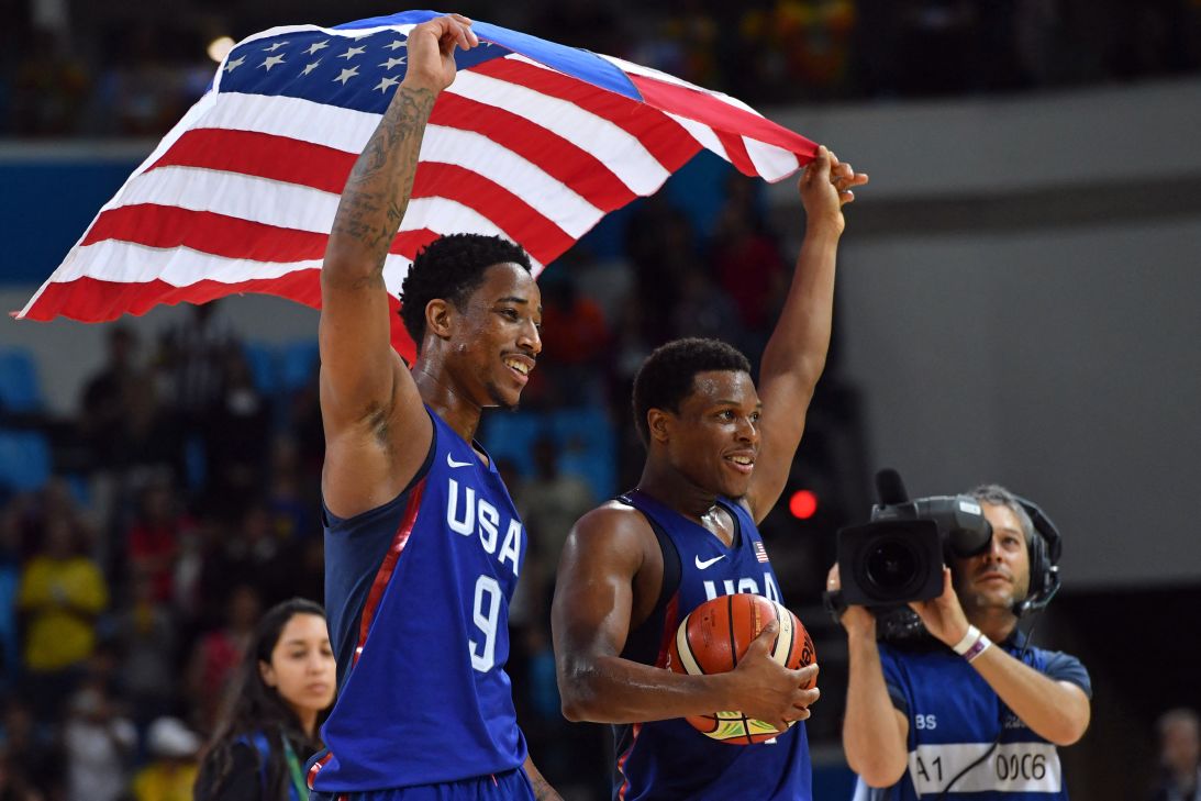 USA guards DeMar DeRozan and Lowry celebrate with the American flag after defeating Serbia during the men's gold medal match against Serbia in Rio de Janeiro on August 21 during the Rio 2016 Olympic Games.