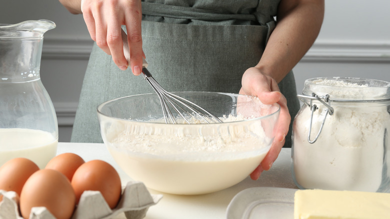Person making dough from scratch