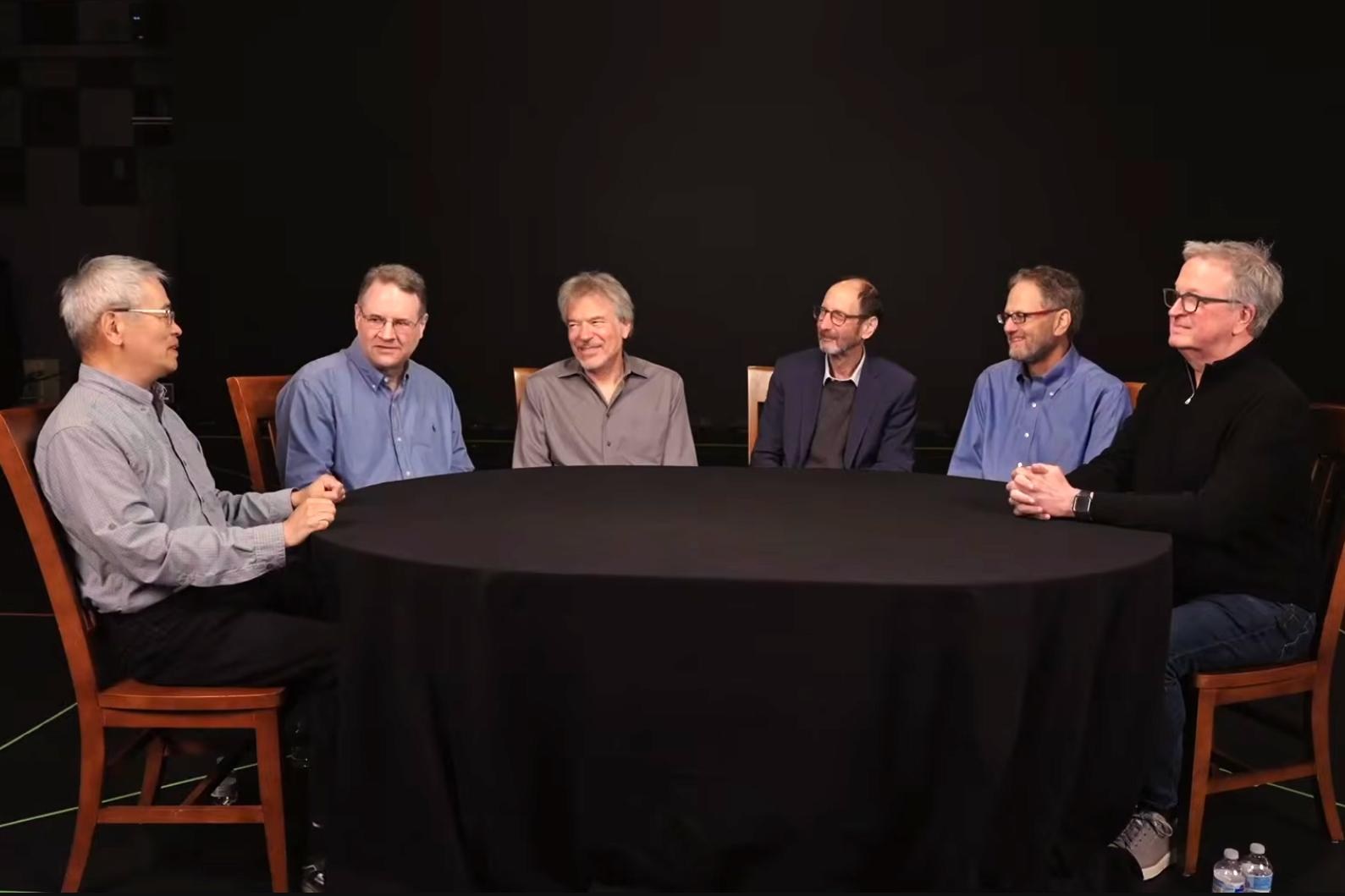 Several founding members of ILM’s CG department sit around a table discussing their work on Terminator 2.